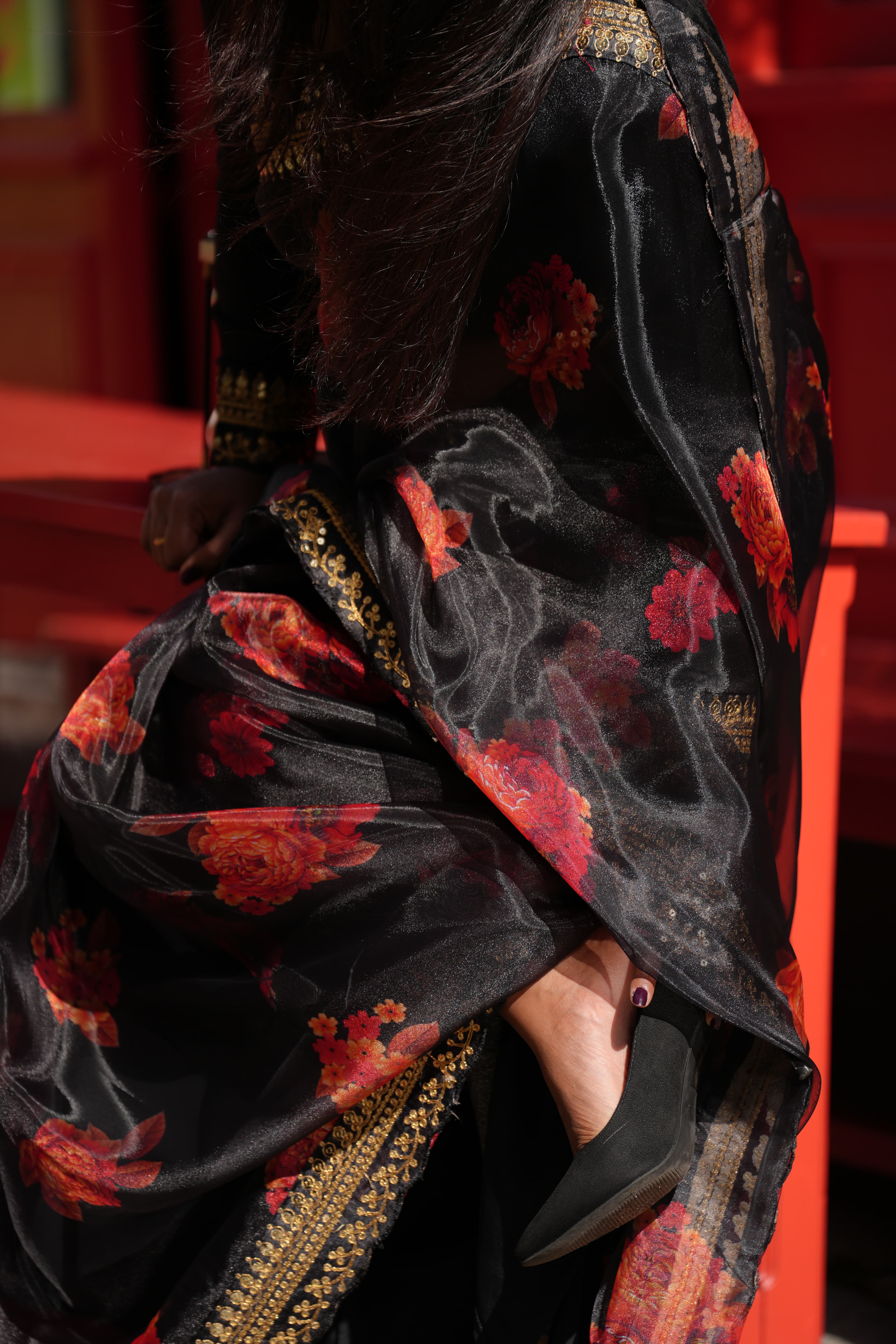 Black saree, hands draping the first pleat