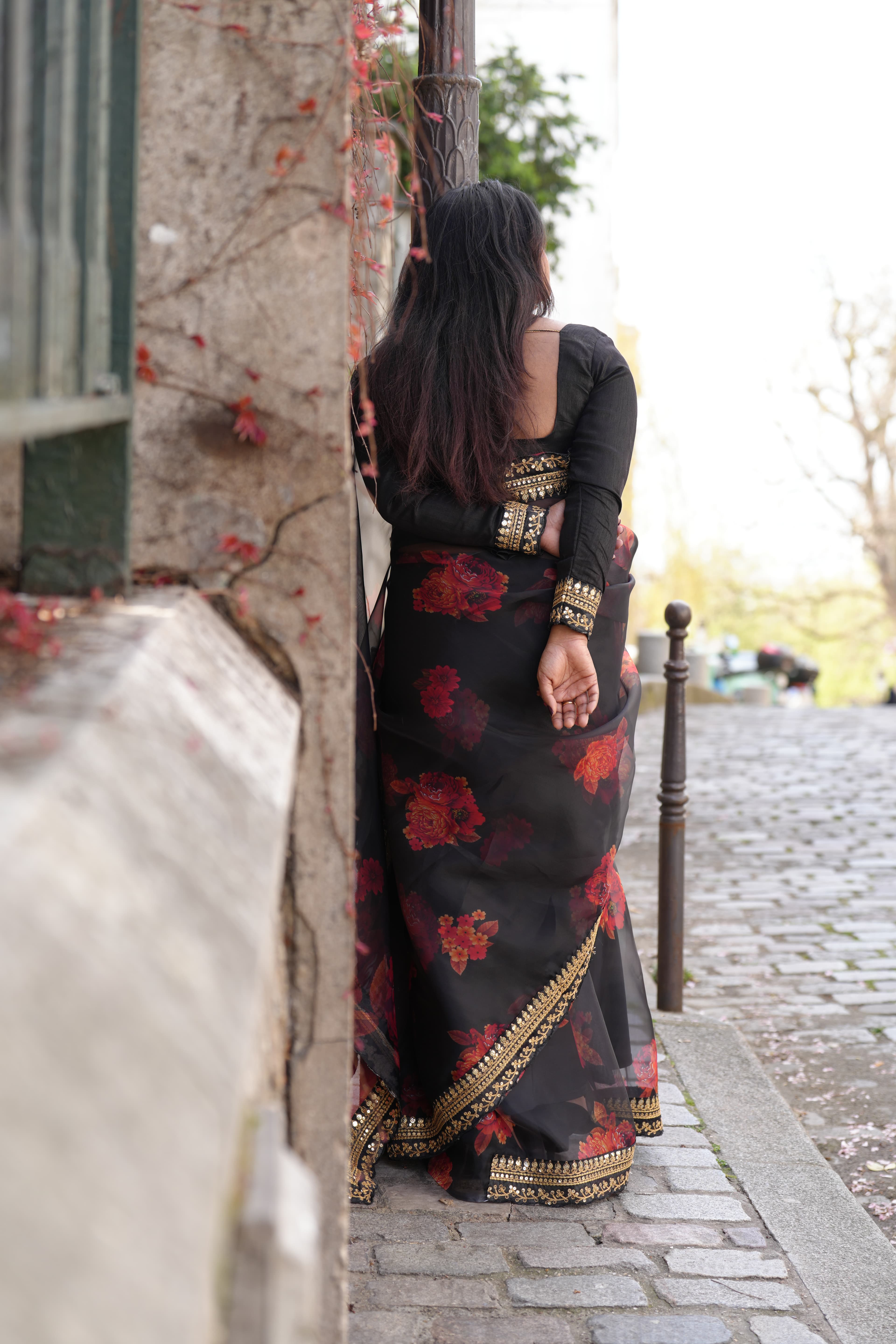A folded saree, lit from one side and laid on raw wood