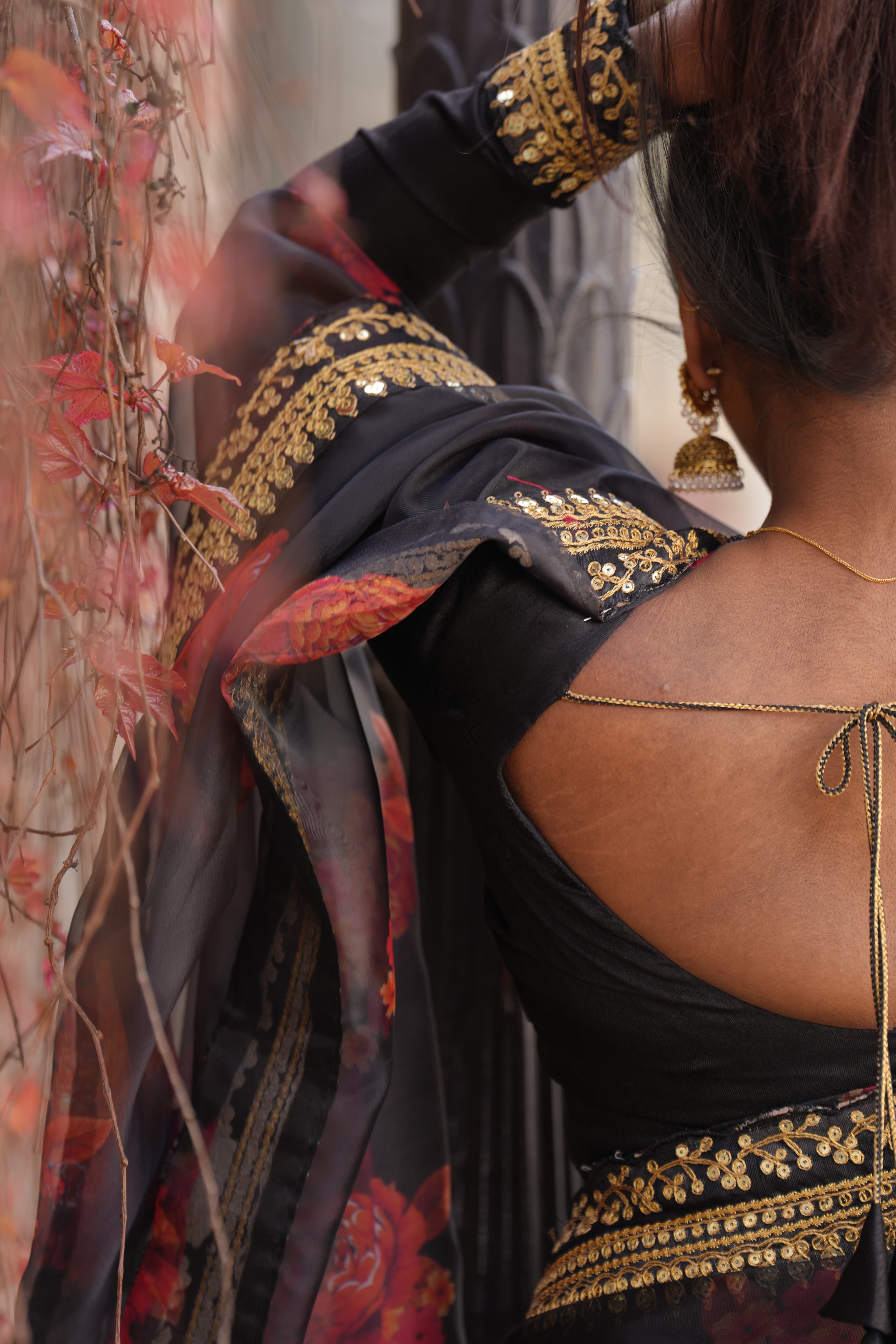 Black saree, the drape held against light